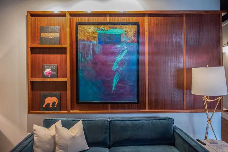 Abstract painting framed in a sapele wood display wall