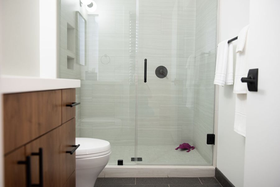 Bathroom with a glass walk-in shower and wood vanity