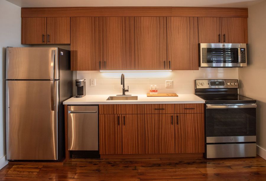 Full kitchen with sapele wood cabinetry and stainless steel appliances