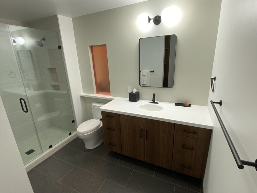 Bathroom with a glass walk-in shower and dark wood vanity